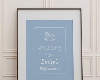 May include: A blue and white baby shower sign with a rocking horse graphic and the text "Welcome to Emily's Baby Shower".