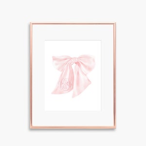 May include: A framed illustration of a pink satin bow with a white monogram in the center.