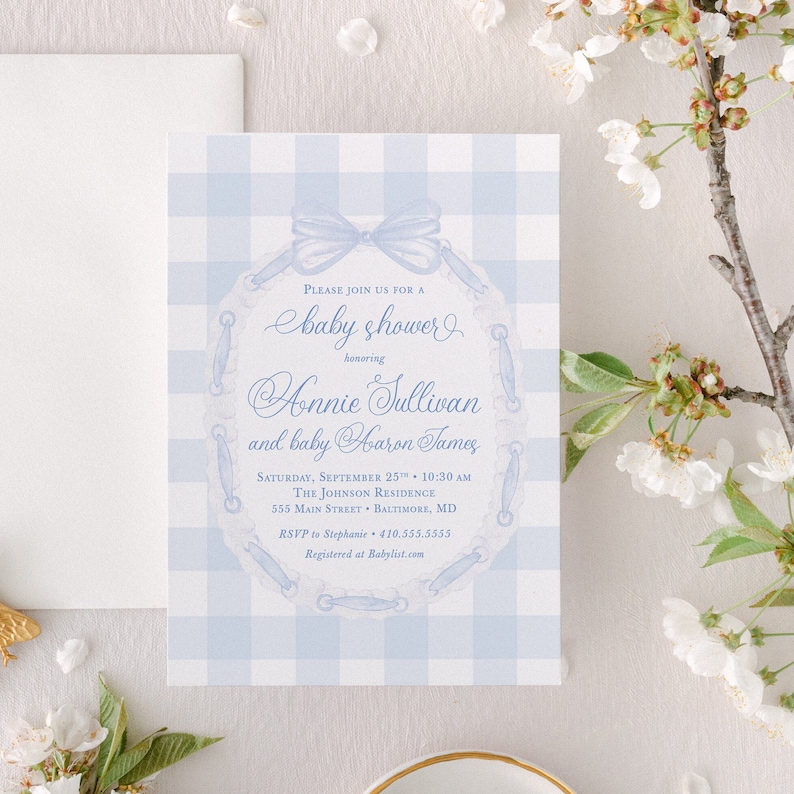 May include: A blue and white gingham baby shower invitation with a blue ribbon and a lace design. The invitation reads "Please join us for a baby shower honoring Honnie Sullivan and baby Aaron James. Saturday, September 25th, 10:30 AM. The Johnson Residence, 555 Main Street, Baltimore, MD. RSVP to Stephanie 410.555.5555. Registered at Babylist.com"