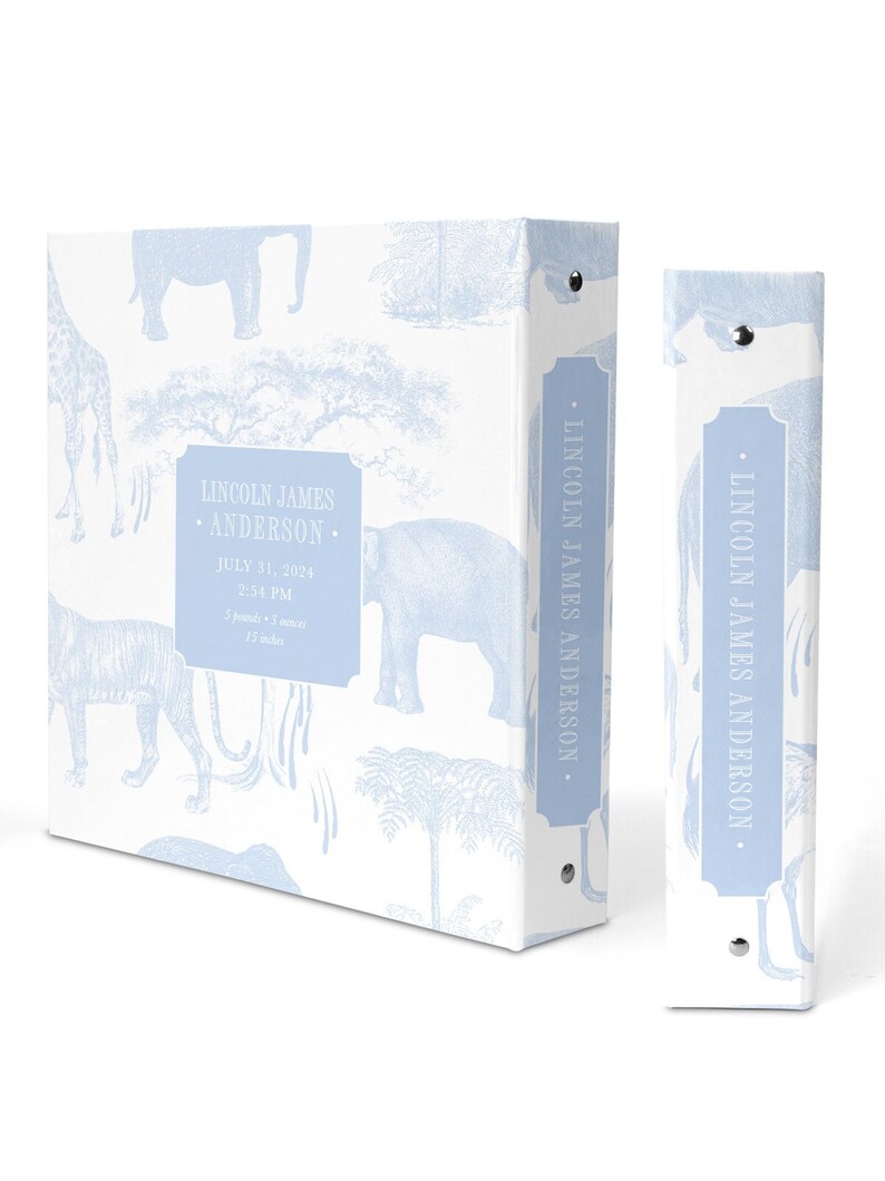 May include: A light blue baby photo album with a white background and a blue and white pattern of animals, including elephants, giraffes, and tigers. The album has a spine with the name "LINCOLN JAMES ANDERSON" printed on it. The front cover has a label with the name "LINCOLN JAMES ANDERSON" and the date "JULY 31, 2024" printed on it.
