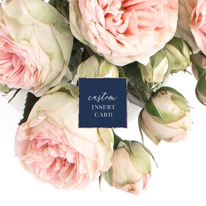 May include: A navy blue card with the text "custom insert card" in white script font. The card is surrounded by pink roses.