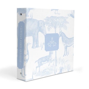 May include: A white binder with a blue and white pattern of animals, including an elephant, zebra, and a bird. The binder has a blue spine with the text "LINCOLN JAMES ANDERSON." on it. The binder also has a blue square with the letter "A" in the center.
