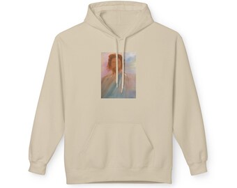 May include: A beige hooded sweatshirt featuring a rectangular graphic print on the centre chest. The print depicts a portrait of a person with long hair and a beard, wearing a light blue garment against a soft, pastel-coloured background.
