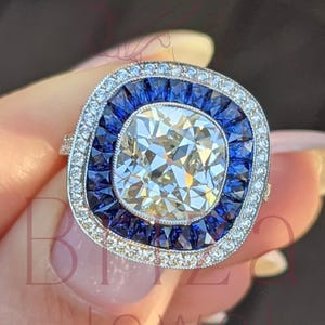 Art Deco Cushion Cut Diamond Halo Ring: Blue Sapphire Accents
