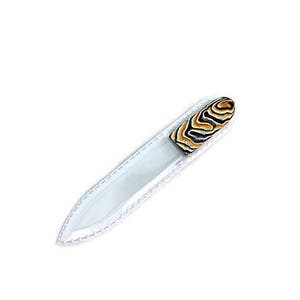 May include: A clear glass nail file with a black and orange striped handle.