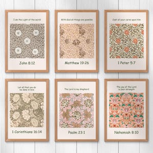 May include: Six framed art prints with floral patterns in various colors, including beige, pink, and orange. Each print features a Bible verse and a corresponding reference. The frames are made of light brown wood.