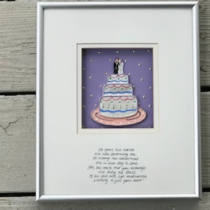 May include: A white frame with a purple background and a white wedding cake with a bride and groom on top. The text in the frame reads: "as your two hearts are now becoming one, so many new adventures are in each day to come. For the vows that you exchange are only the start of the love and life experiences waiting to fill your heart!"