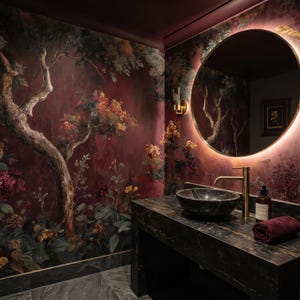 May include: A luxurious powder room with a dark marble vanity and a round mirror with a warm glow. The walls are adorned with a floral mural in shades of burgundy, green, and gold. A dark stone sink and gold faucet complete the elegant design.