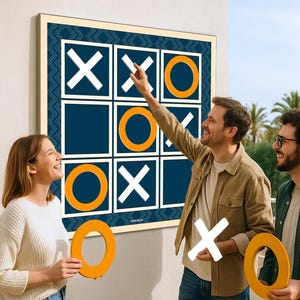 May include: A large outdoor tic-tac-toe game with a navy blue background and white grid. The game is being played by three people, with one person pointing at the board. The game pieces are white X's and orange O's. Palm trees are visible in the background.