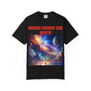 May include: Black t-shirt with a colourful graphic depicting a cosmic scene with planets and nebulae, and a silhouetted figure. The text "UNIVERSE OVERRIDE CODE 0010110" is printed in red above the graphic. A short-sleeved tee.