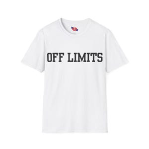 May include: White t-shirt with the text "OFF LIMITS" printed in black, centered on the front. The shirt has short sleeves and a crew neck. A small tag is visible at the neckline.