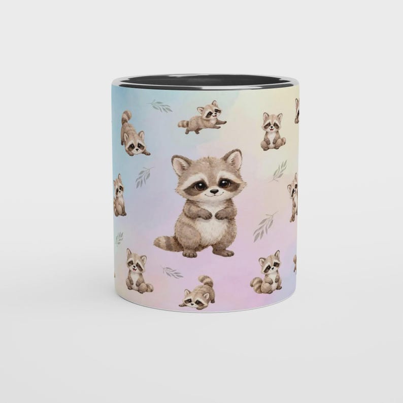 May include: A ceramic mug featuring a repeating pattern of illustrated raccoons in various poses against a soft, pastel-colored watercolor background. A larger raccoon illustration is centered on the front, and the mug has a solid black interior rim.
