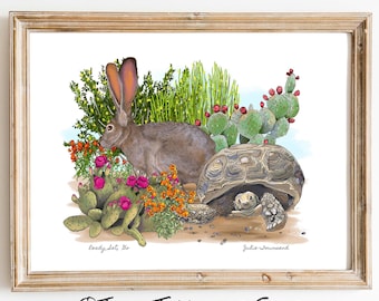 May include: A framed art print featuring a brown jackrabbit with large ears and a tortoise in a desert landscape with green cacti, red flowers, and orange blossoms. The text "Ready, Lets Go" and "Julie Townsend" is printed at the bottom.