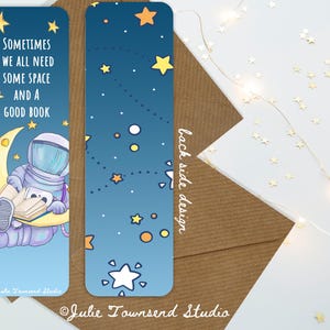 May include: Two space-themed bookmarks. One features an astronaut reading on a crescent moon with the text "Sometimes we all need some space and a good book." The other has a starry night design. Both have rounded corners and the text "back side design."