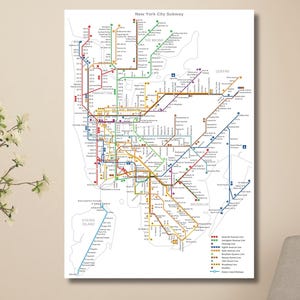 May include: A rectangular wall art print featuring a detailed New York City subway map with multicolored transit lines on a white background. The map displays various train routes, station markers, and a legend in the lower right corner.