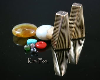 A Pair of Large Art Deco Cones designed with a twist in bronze by Kim Fox