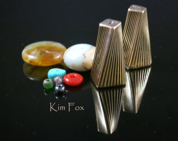 A Pair of Large Art Deco Cones designed with a twist in bronze by Kim Fox