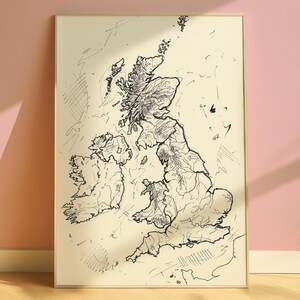 May include: A rectangular framed wall art print featuring a black ink line drawing of the British Isles on a cream-colored background. The map illustration displays the geographical outlines of Great Britain and Ireland with sketch-like details.