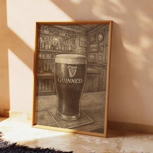 May include: A framed print depicting a pint of Guinness stout in a pub. The glass is filled with dark beer and a creamy head, with the Guinness logo. The background shows a bar with bottles and framed pictures.