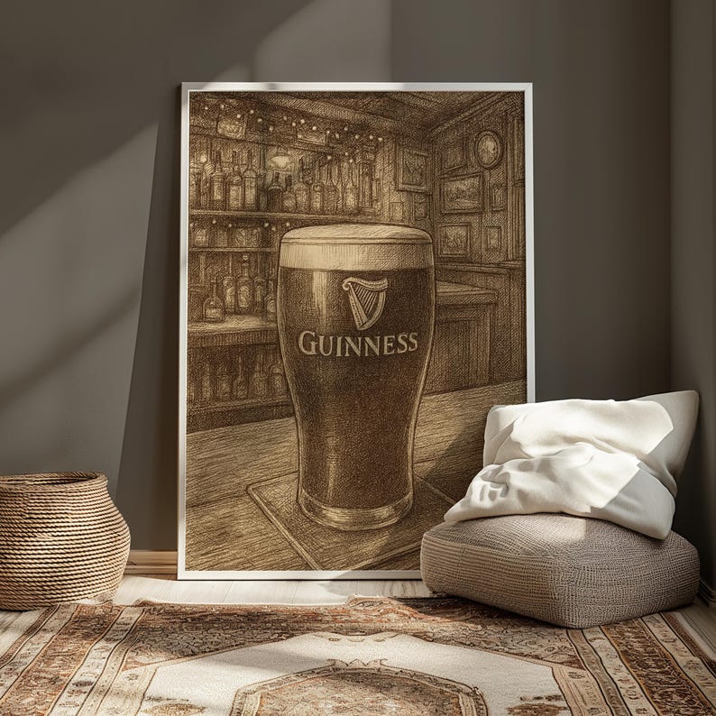 May include: A framed sepia-toned print of a pint of Guinness stout in a pub setting. The glass is filled with dark beer and topped with a creamy head. The Guinness logo is visible on the glass.