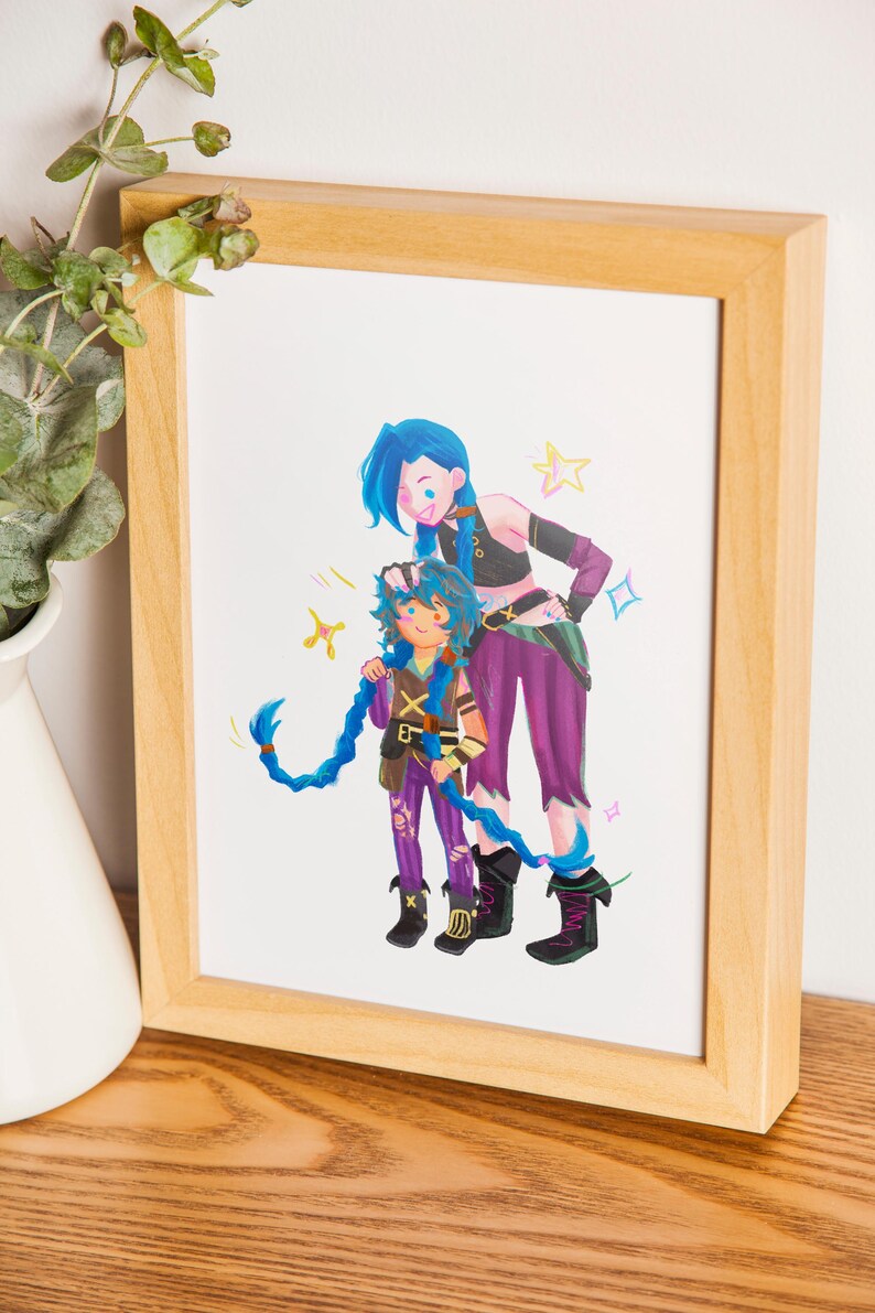 May include: A framed print depicting two cartoon characters with blue hair and purple clothing. The characters are standing together, with one appearing to support the other. The artwork is presented in a wooden frame.