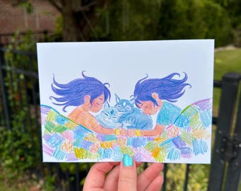 May include: A rectangular art print featuring a coloured pencil illustration of two figures with long purple hair lying under a colourful patchwork quilt, embracing two small blue cats. The quilt displays various elemental symbols.
