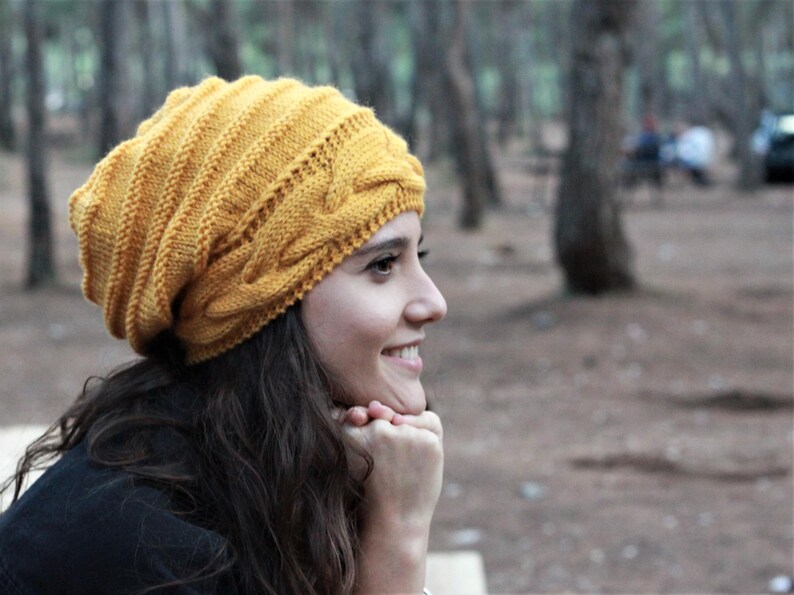 Pode incluir: Gorrinho de malha amarelo mostarda com design de tran&ccedil;a. O chap&eacute;u &eacute; feito de um fio macio e texturizado e tem uma bainha canelada. Um acess&oacute;rio quente e elegante para o clima frio.