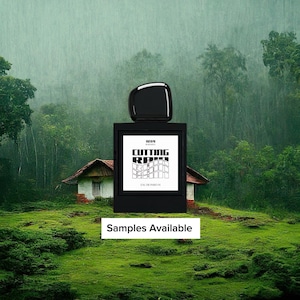 May include: A black perfume bottle with a rectangular label featuring the text "CUTTING ROOM" in a modern font. The bottle is set against a backdrop of a small house and lush green landscape. The words "Samples Available" are at the bottom.