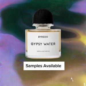 May include: A clear glass perfume bottle with a black cap. The label reads "BYREDO GYPSY WATER ABSOLU DE PARFUM." The text "Samples Available" is displayed on a white rectangle below the bottle. The background has a colorful, abstract design.