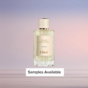 May include: A rectangular perfume bottle with a cream-colored label and a gold cap. The label reads "ATELIER DES FLEURS CEDRUS Chloé." The bottle is clear, allowing the light-yellow liquid inside to be visible. The text "Samples Available" is at the bottom.