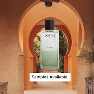 May include: A rectangular glass perfume bottle with a black cylindrical cap, featuring a pale green liquid base and a white label printed with the text LOEWE AIRE SUTILEZA Elixir. Below the bottle, a white rectangular sign reads Samples Available.