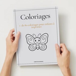 May include: A colouring book titled "Coloriages" with a butterfly illustration on the cover. The cover also includes the text "+ de 80 coloriages pour enfants à imprimer". The book is held by two hands.