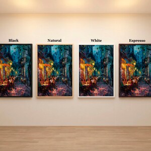 May include: Four framed art prints of a European street scene, each with a different frame color: black, natural, white, and espresso. The artwork depicts a nighttime scene with warm lighting and figures at tables.