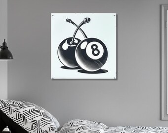 May include: Black and white wall art featuring a stylized design of two cherries, one of which is an eight ball. The artwork is mounted on a white square and hangs on a gray wall. The image is a modern take on a classic theme.