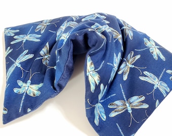 May include: A navy blue neck wrap featuring a repeating pattern of light blue and gold dragonflies. The wrap is designed to conform to the neck and shoulders. The fabric appears to be soft and comfortable.
