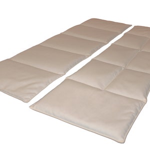 May include: Two beige quilted mattress toppers, each with six rectangular quilted sections. The toppers are laid out side by side, with the top edges aligned.