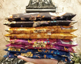 May include: A stack of six colorful fabric pillow covers with a moon and star pattern. The covers are made of a soft, comfortable material and are perfect for adding a touch of whimsy to any room.