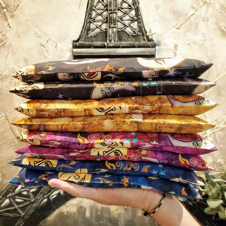May include: A stack of six colorful fabric pillow covers with a moon and star pattern. The pillow covers are made of a soft, comfortable fabric and are perfect for adding a touch of whimsy to any room.