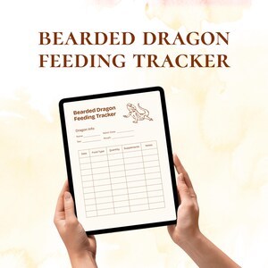 May include: A digital tablet showing a "Bearded Dragon Feeding Tracker" with sections for dragon details and feeding records. The tablet is held in hands, set against a soft, watercolour-style backdrop. The text "BEARDED DRAGON FEEDING TRACKER" is at the top.
