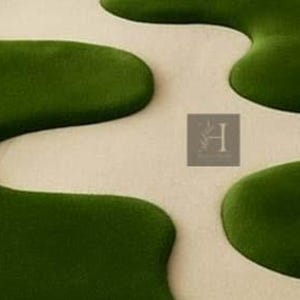 May include: A close-up of a rug with a unique design. The rug features a cream-colored background with large, organic shapes in a deep green color. The shapes are reminiscent of lily pads or flowing water, creating a modern and artistic look.