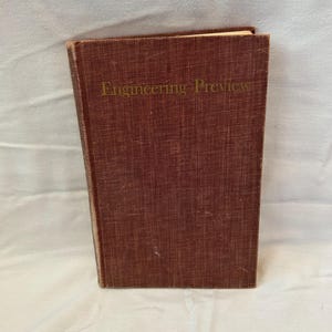 May include: A hardcover book with a maroon cover. The title "Engineering Preview" is printed in gold lettering across the top. The book appears to be vintage, with slight wear on the edges.