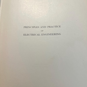 May include: A page from a book with the title "PRINCIPLES AND PRACTICE OF ELECTRICAL ENGINEERING" printed in black ink. The text is centered on the page, with a simple, classic font. The paper has a slightly off-white color.