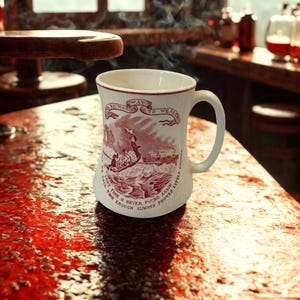 May include: A white ceramic mug with a red graphic illustration of a boat on water and text that reads "Way to Wealth" and "Lost time is never found again" along with "Dost thou love life then do not squander time for that is the stuff life is made of."