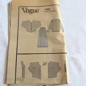 May include: Vintage Vogue sewing pattern from 1985. The pattern features illustrations of a jacket, skirt, and other garment pieces. The pattern is printed on aged paper with the Vogue logo visible.