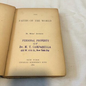 May include: Open book with the title "The Faiths of the World" and the text "Personal Property of Dr. M. T. Campanella, 430 W. 48th St., New York City." The book was published in 1882 by Charles Scribner's Sons, New York.
