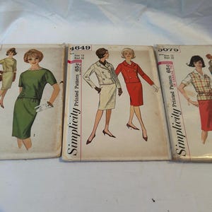 May include: Three vintage Simplicity sewing pattern envelopes labeled 4769, 4649, and 5075. Each envelope features illustrations of women wearing various skirt and jacket outfits, including a green dress, a white blazer, and a plaid shirt with a red skirt.