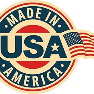 May include: A circular emblem with the text "MADE IN USA AMERICA" in a navy blue and red design. The emblem includes a waving American flag and a white star.