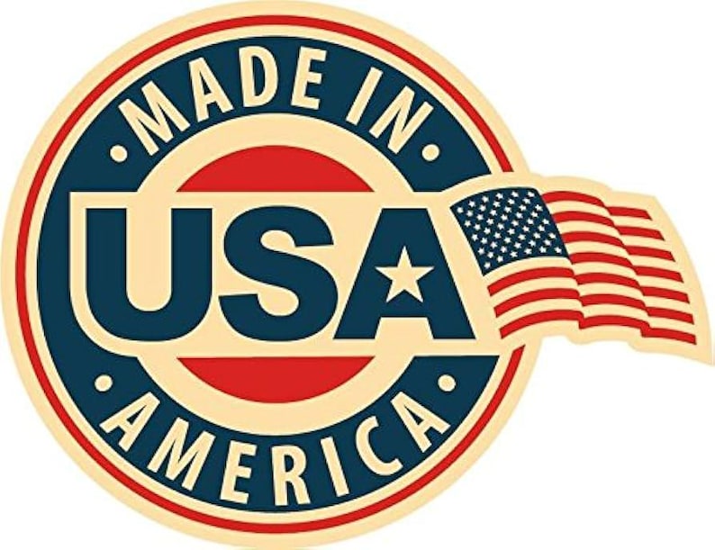 May include: A circular emblem with the text "MADE IN USA AMERICA" in a navy blue and red design. The emblem includes a waving American flag and a white star.