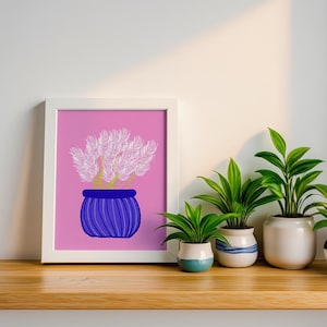 May include: A framed art print with a pink backdrop, showcasing a blue pot filled with pink, feathery flowers. Below, a wooden shelf displays several potted green plants, creating a colourful and decorative arrangement.