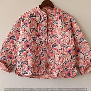 May include: A white ceramic mug with a black handle and the text "But First, Coffee" in a bold, black font. The mug is set against a blurred background, suggesting a cozy setting.